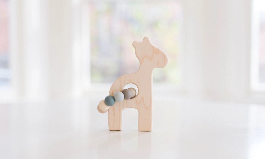 giraffe grasping wooden b aby toy with teething beads
